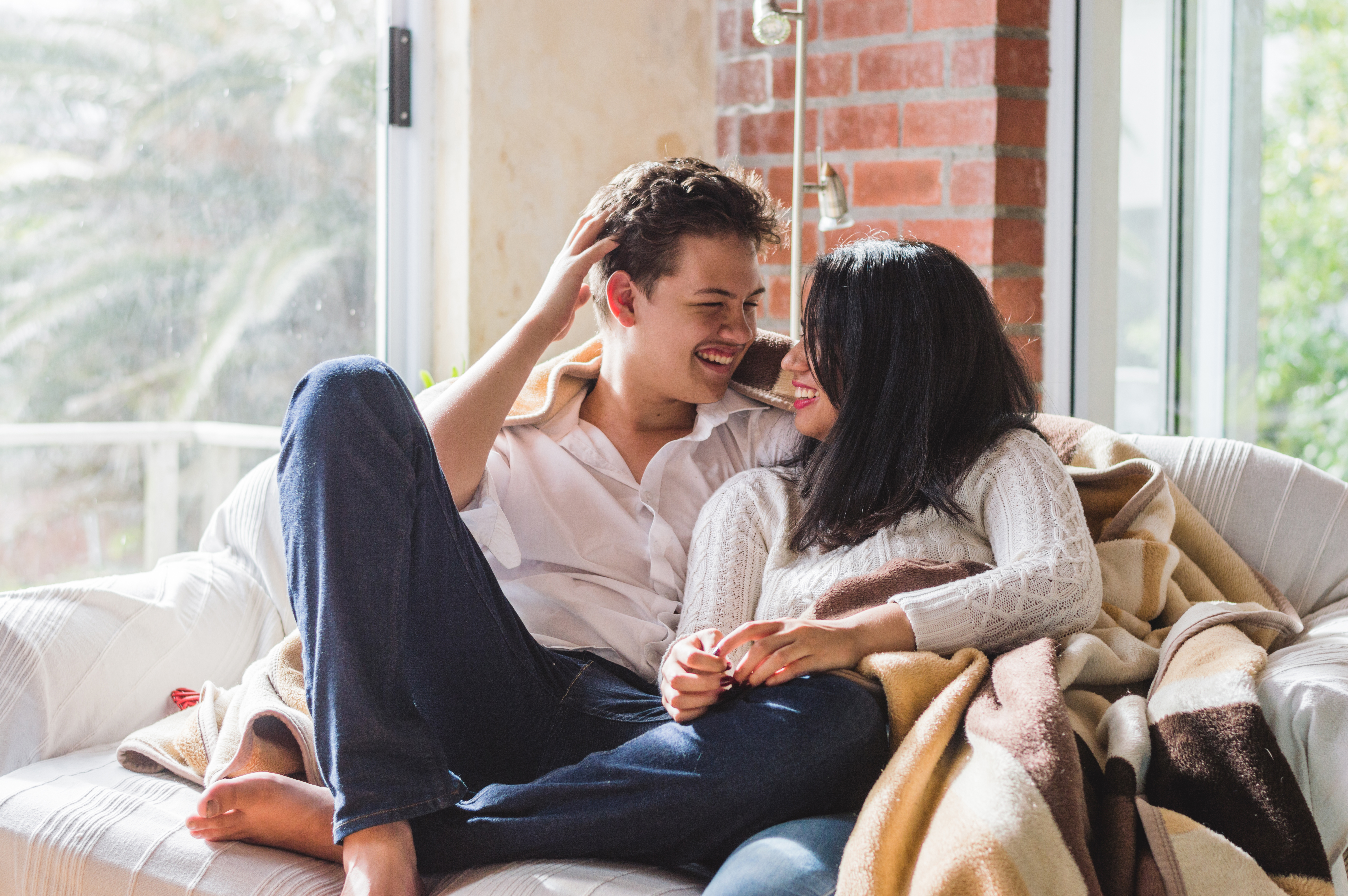 smiling-couple-covered-with-blanket